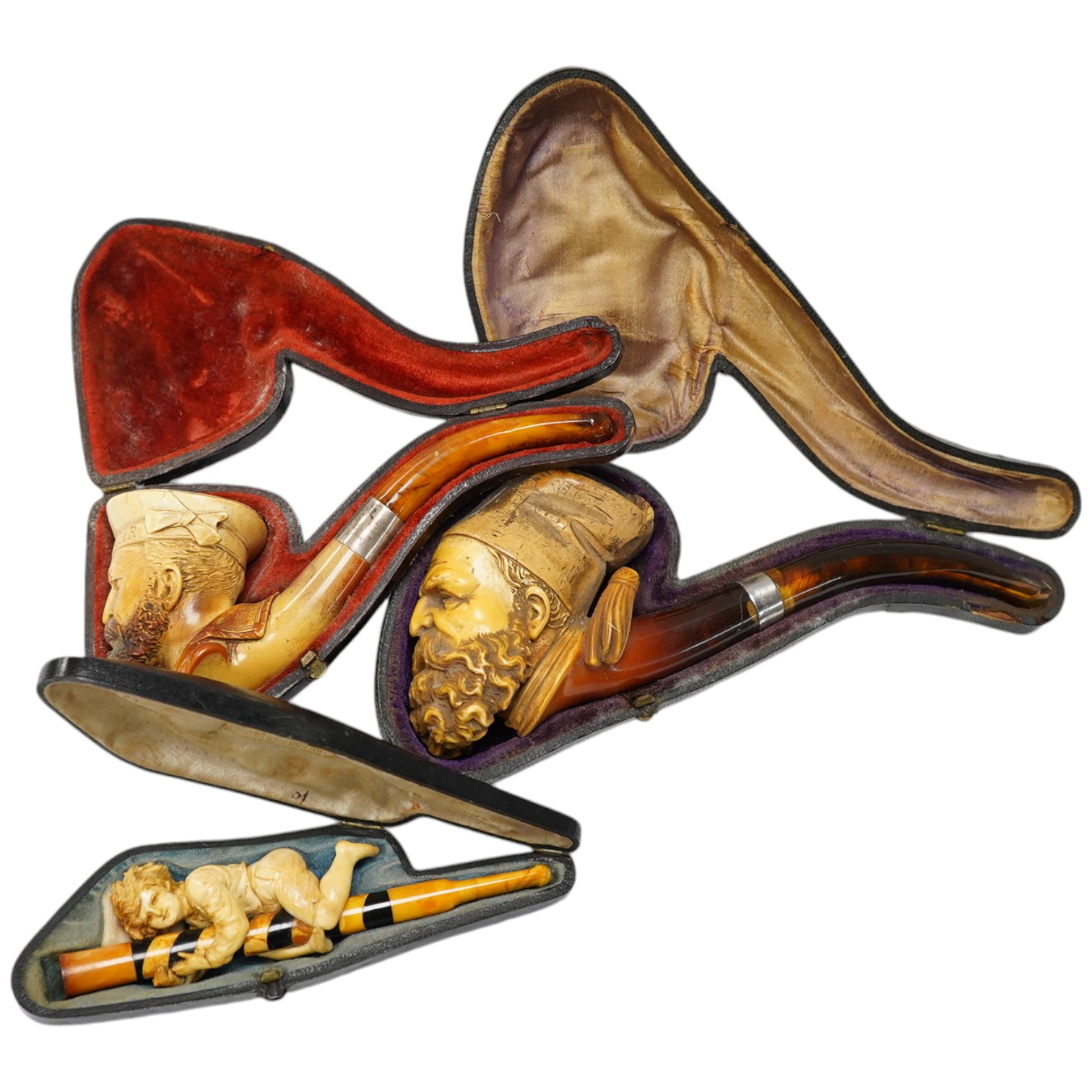 Three cased assorted Meerschaum pipes; sailor, boy on a pole and a Turk, largest Turk 19cm long. Condition - all pipes have damage either in pipe bowls or amber, cases worn